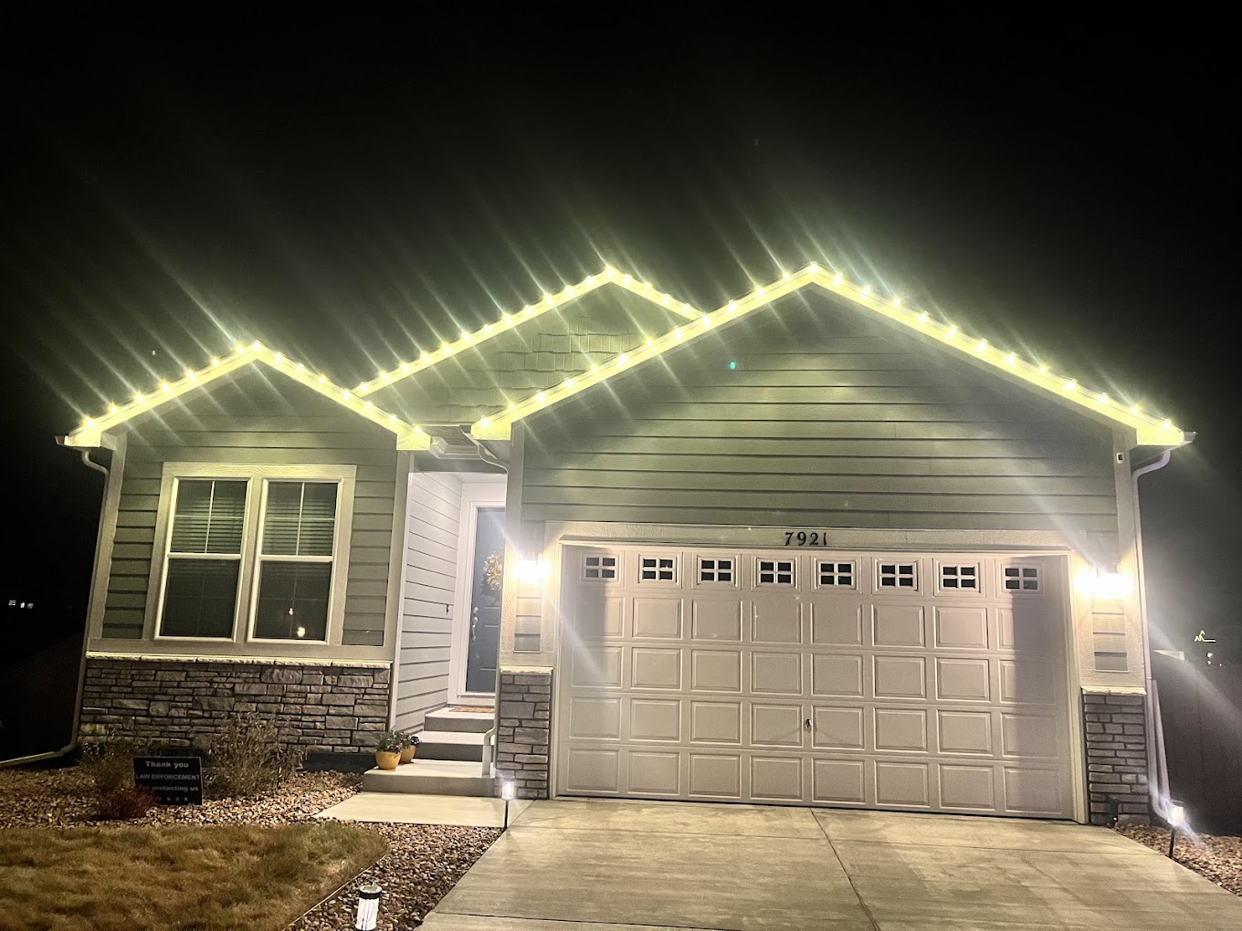Warm white roofline Christmas light installation on a Front Range home by our crew